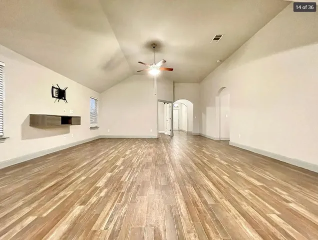 a view of a livingroom with a furniture and chandelier fan