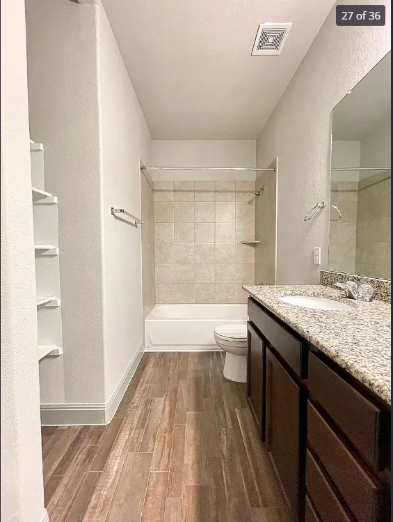 205 Jude Circle Leander, TX 78641 - Photo 25 of 36 a bathroom with a granite countertop sink a toilet a mirror and bathtub