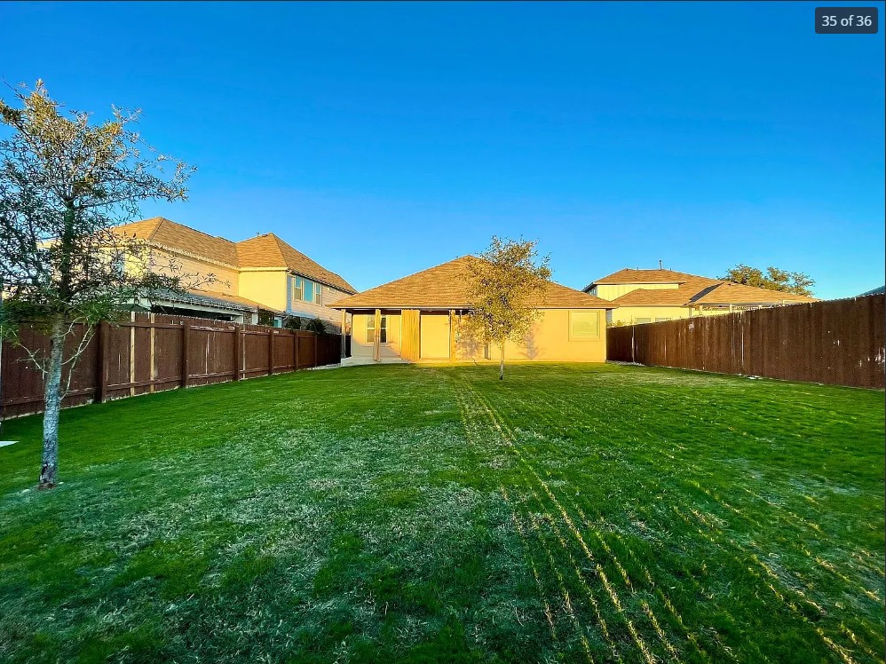 205 Jude Circle Leander, TX 78641 - Photo 33 of 36 a view of a backyard with table and chairs and a barn