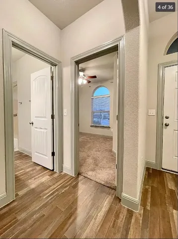 a view of a room with wooden floor and a bathroom
