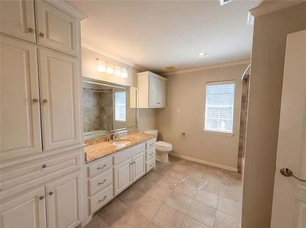 a bathroom with a granite countertop sink mirror and double