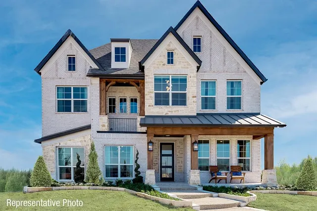 a front view of a residential apartment building with a yard
