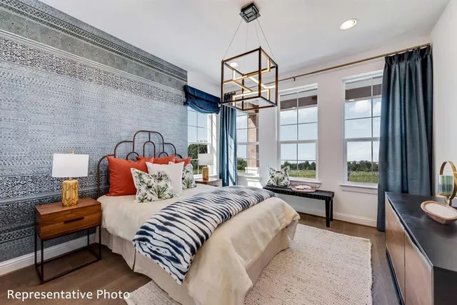 a bedroom with a bed a flat screen tv and a couch