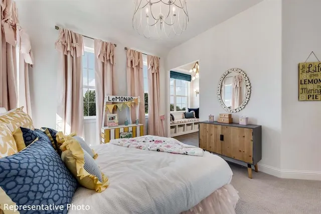 a bedroom with a large bed and a chandelier