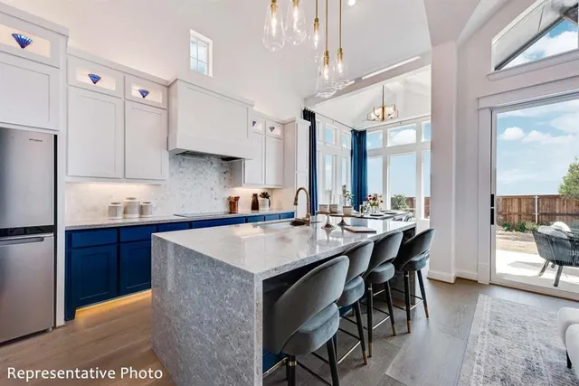 a kitchen with a table chairs sink and cabinets