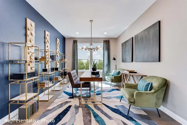 a living room with furniture or chandelier and a wooden floor