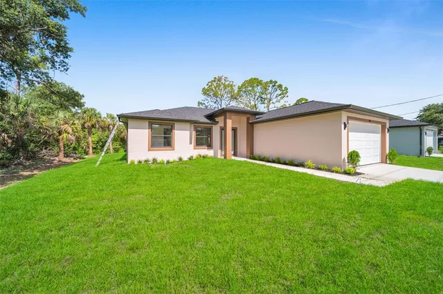 a front view of house with a garden