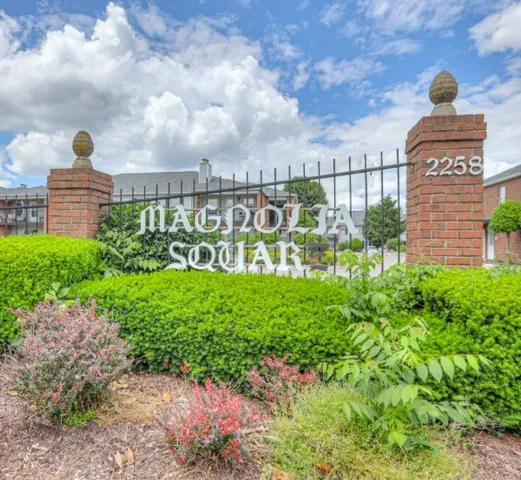 an empty room with windows and fireplace