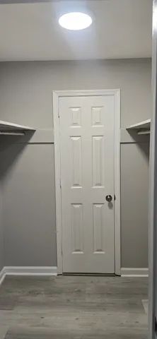 a view of a room with wooden floor and windows