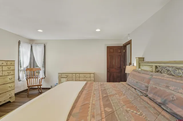 a bedroom with a large bed and a closet