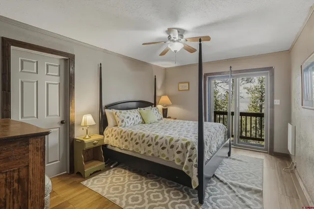 a bedroom with a large bed and a chandelier