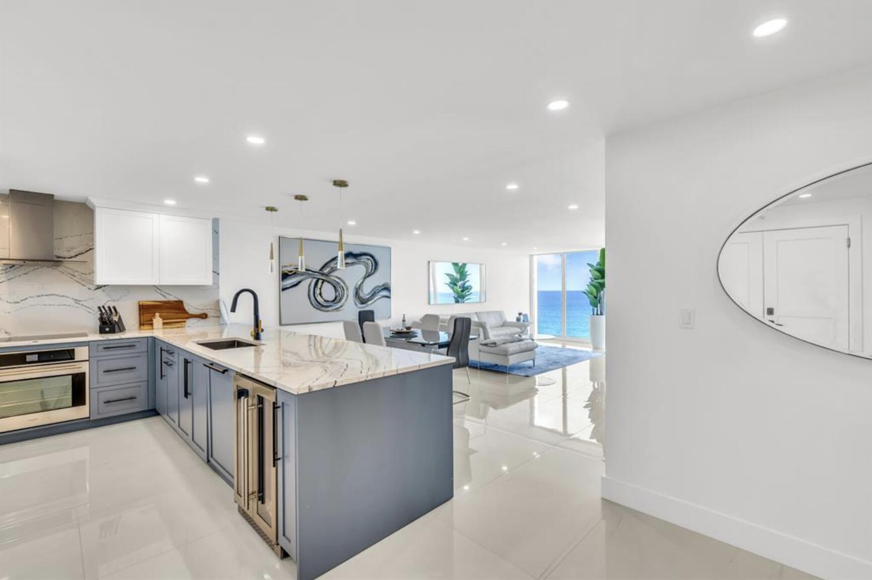 a large kitchen with granite countertop a sink a stove and cabinets