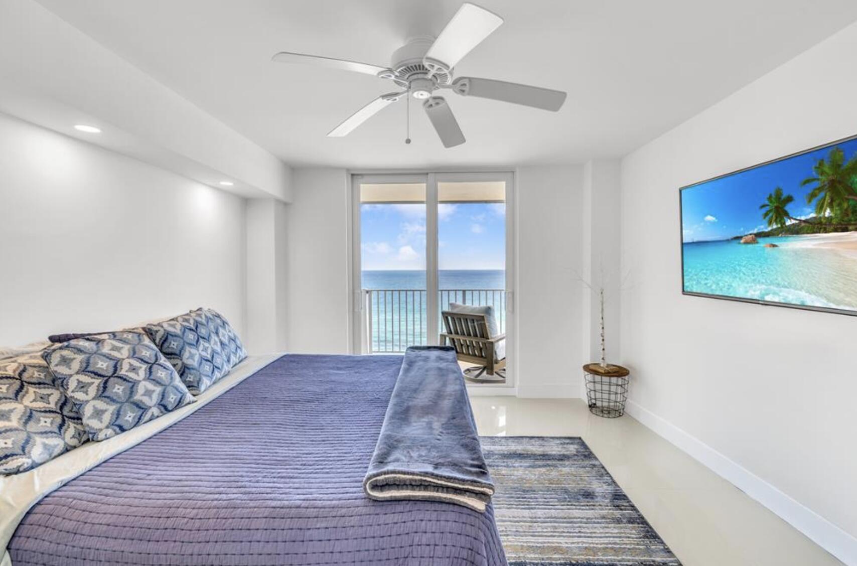 3000 South Ocean Boulevard, Unit 1405 Boca Raton, FL 33432 - Photo 11 of 17 a spacious bedroom with a large bed and a chandelier