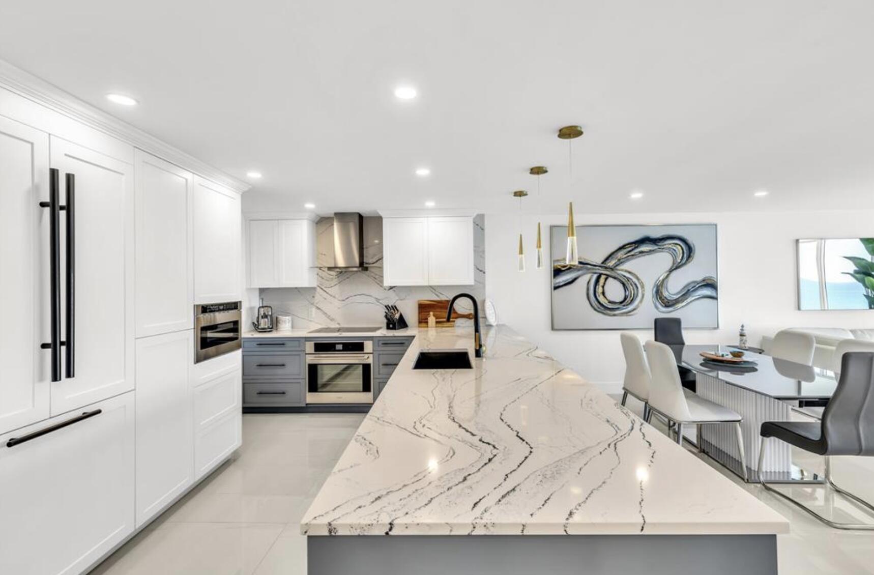 3000 South Ocean Boulevard, Unit 1405 Boca Raton, FL 33432 - Photo 2 of 17 a kitchen with stainless steel appliances kitchen island granite countertop a stove a sink a refrigerator and white cabinets with wooden floor