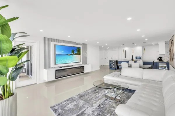a living room with furniture a rug and white walls
