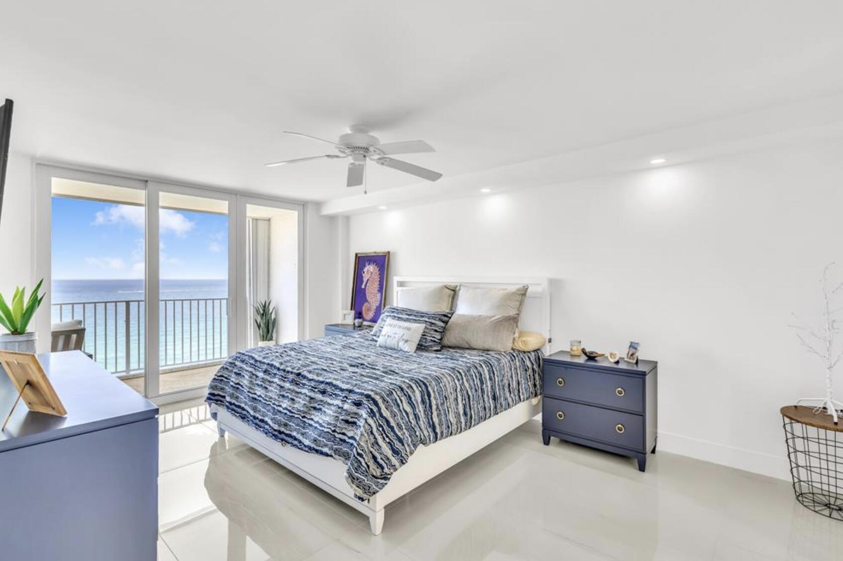 3000 South Ocean Boulevard, Unit 1405 Boca Raton, FL 33432 - Photo 8 of 17 a bedroom with a bed couch and a large window