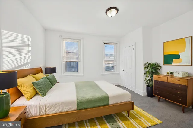 a bedroom with a bed and a couch