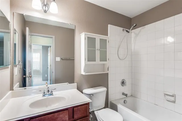 a bathroom with a sink toilet a mirror and shower