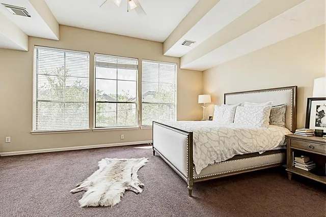 a spacious bedroom with a bed and a window