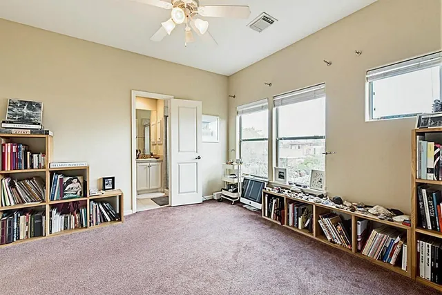 a room with lots of furniture and a book shelf
