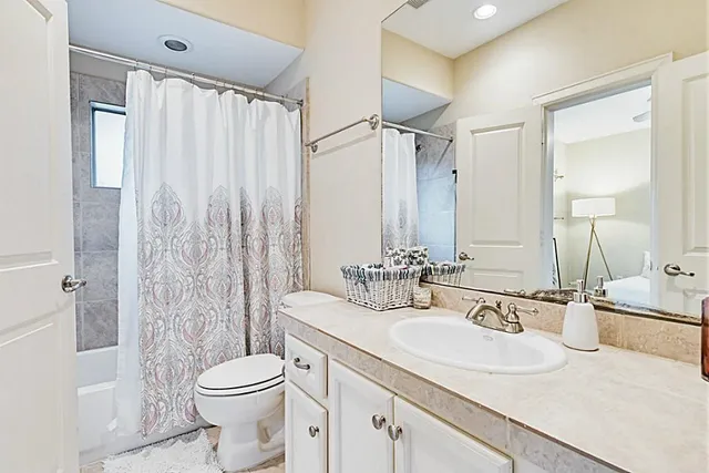 a bathroom with a double vanity sink toilet and shower