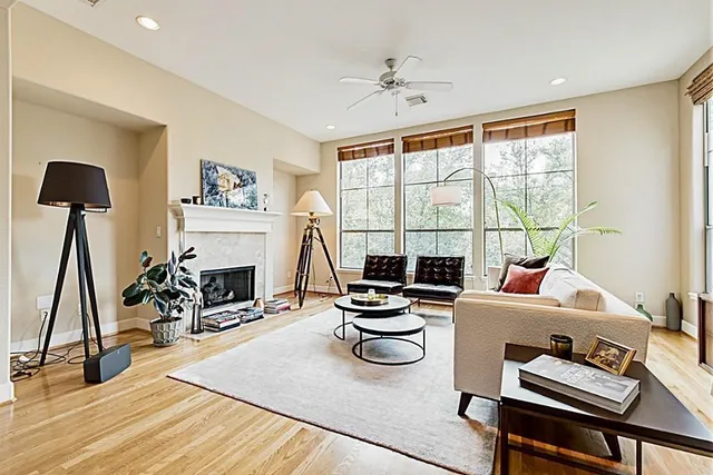 a living room with furniture a fireplace and a flat screen tv