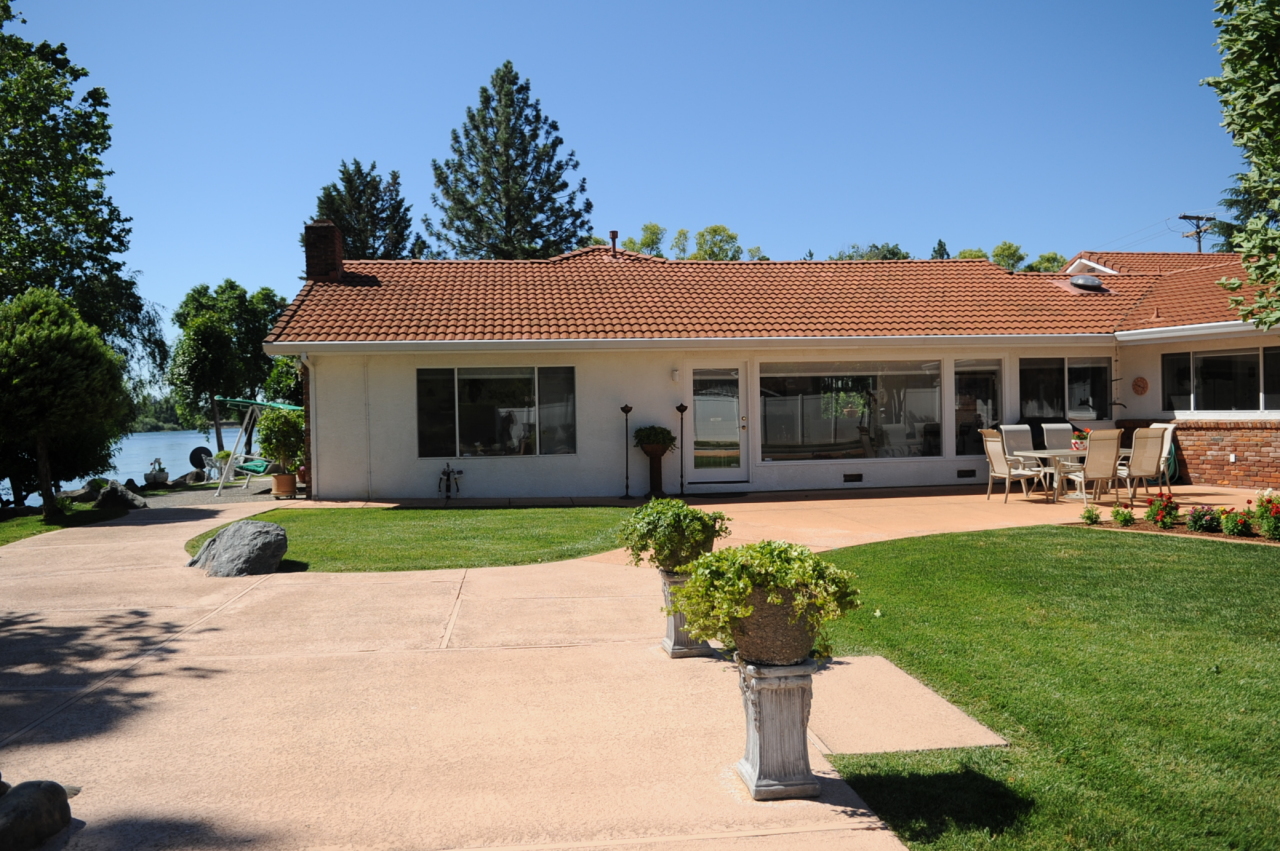 6471 Riverside Drive Redding, CA 96001 - Photo 15 of 56 a front view of a house with a garden and porch