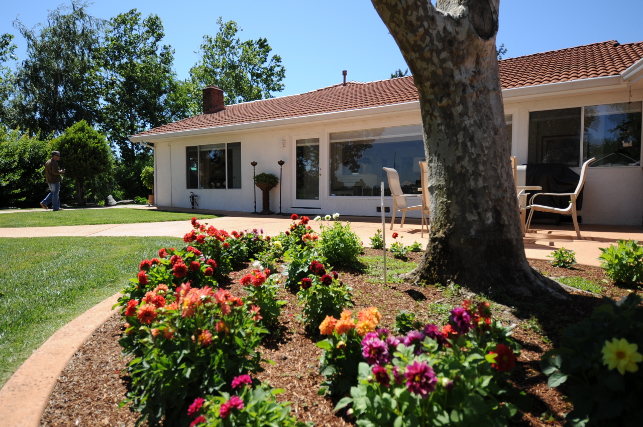 6471 Riverside Drive Redding, CA 96001 - Photo 27 of 56 a front view of a house with a yard and fountain