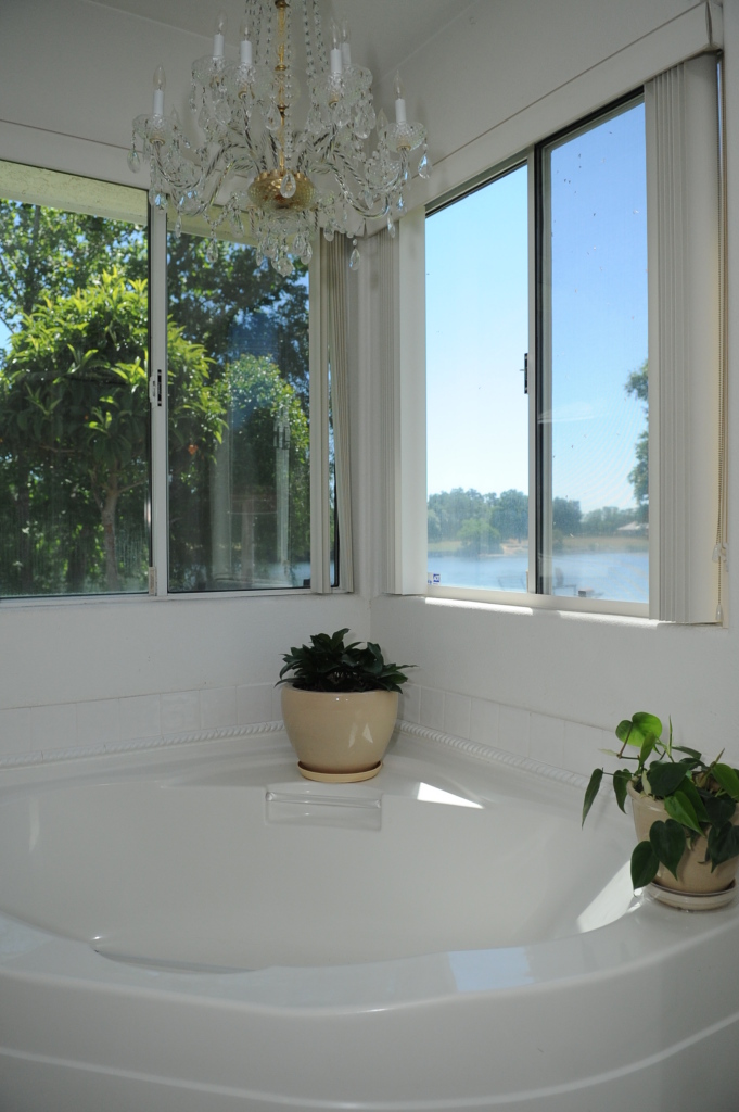 6471 Riverside Drive Redding, CA 96001 - Photo 33 of 56 a white bath tub sitting in front of a window