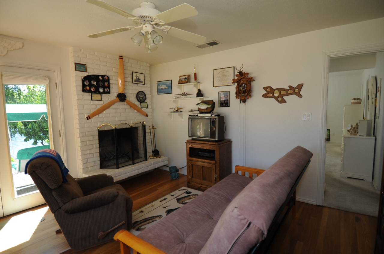 6471 Riverside Drive Redding, CA 96001 - Photo 34 of 56 a living room with furniture a flat screen tv and a fireplace