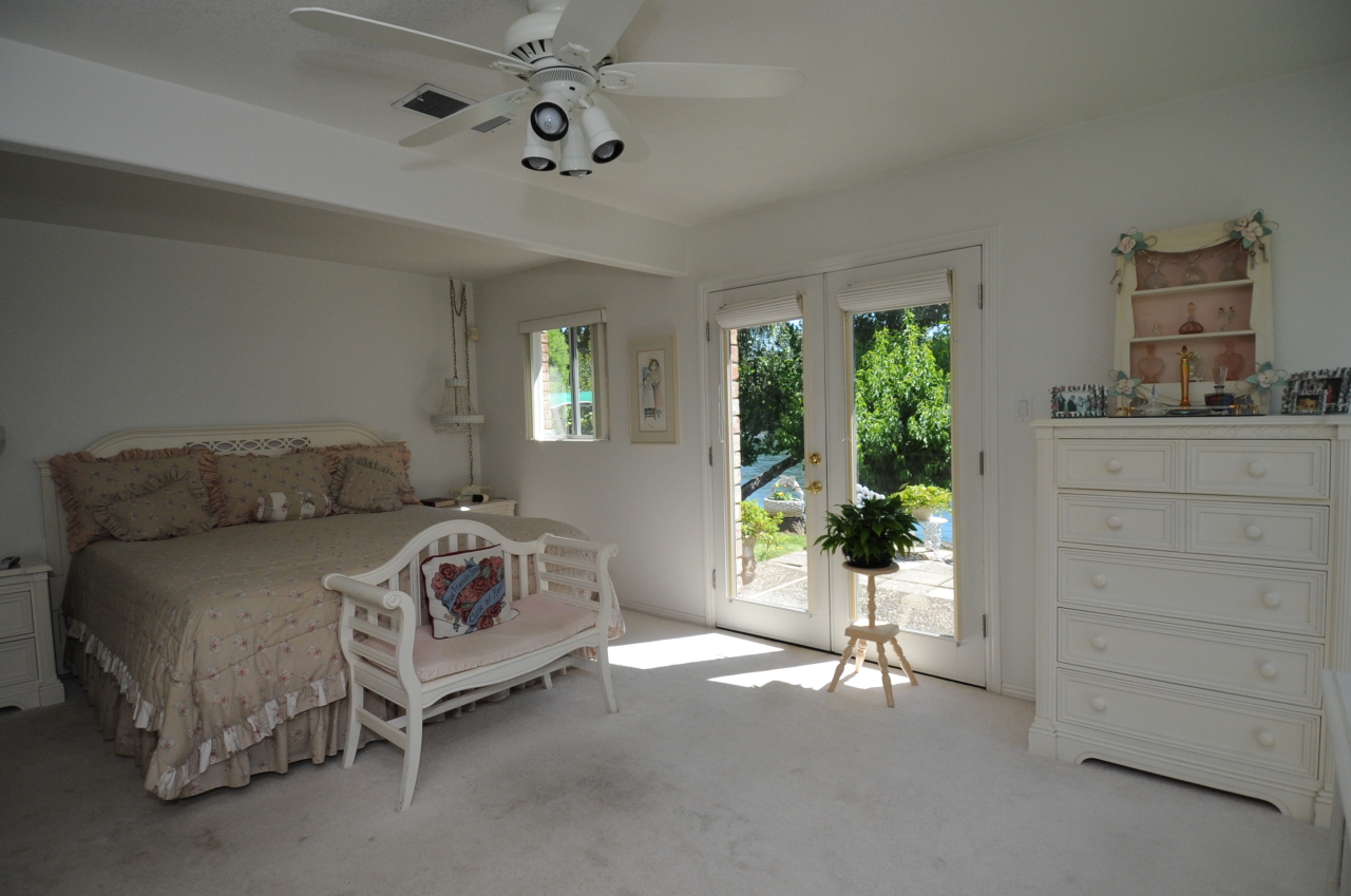 6471 Riverside Drive Redding, CA 96001 - Photo 35 of 56 a bedroom with a bed and large windows