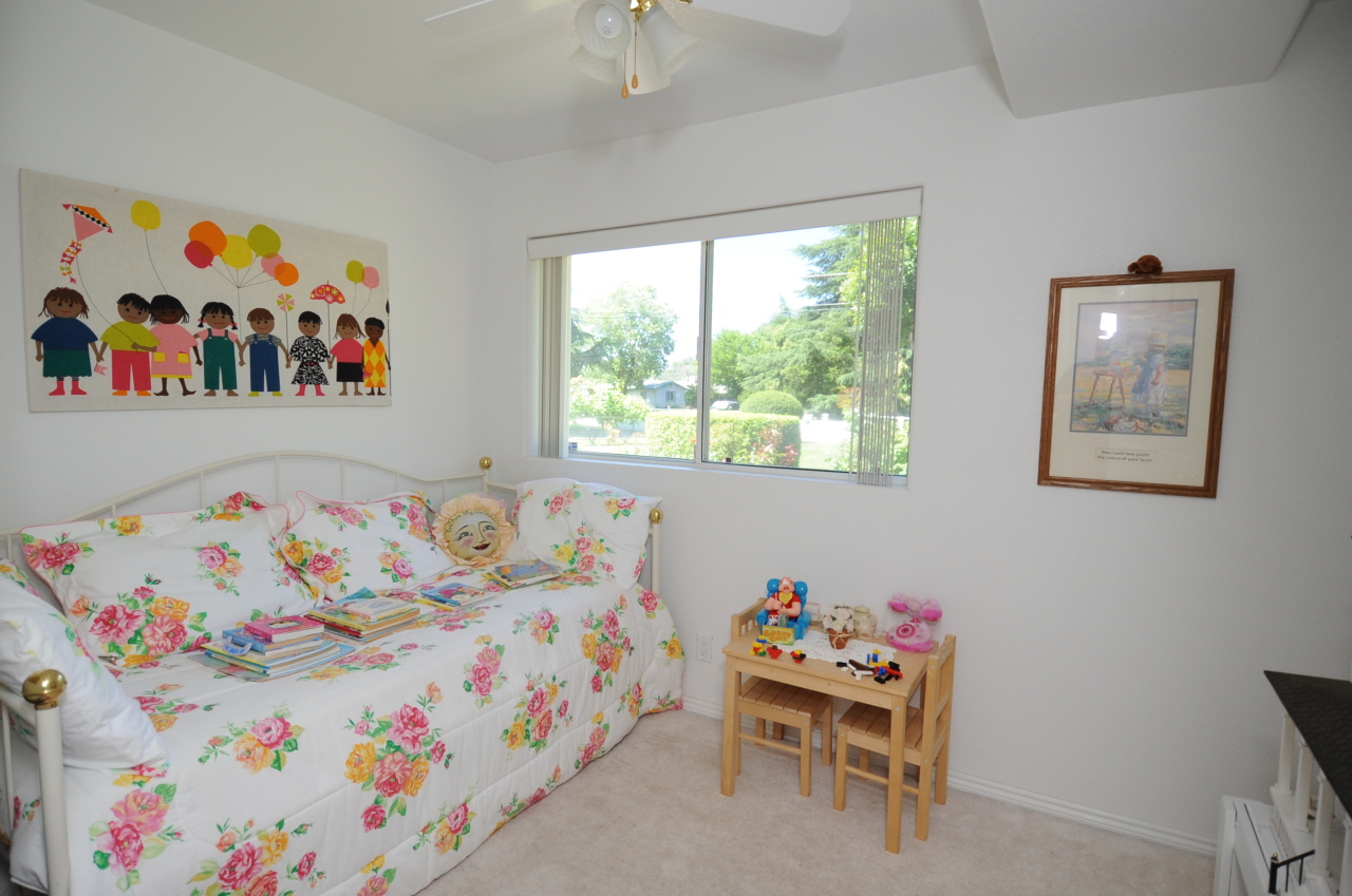 6471 Riverside Drive Redding, CA 96001 - Photo 49 of 56 a bedroom with toys and a book shelf