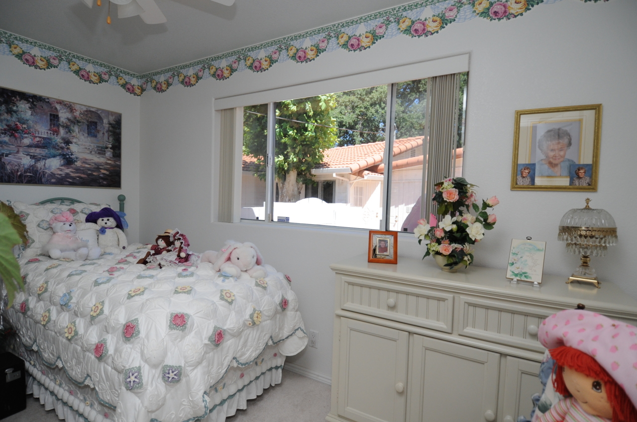 6471 Riverside Drive Redding, CA 96001 - Photo 50 of 56 a bedroom with a bed and a dresser next to a window