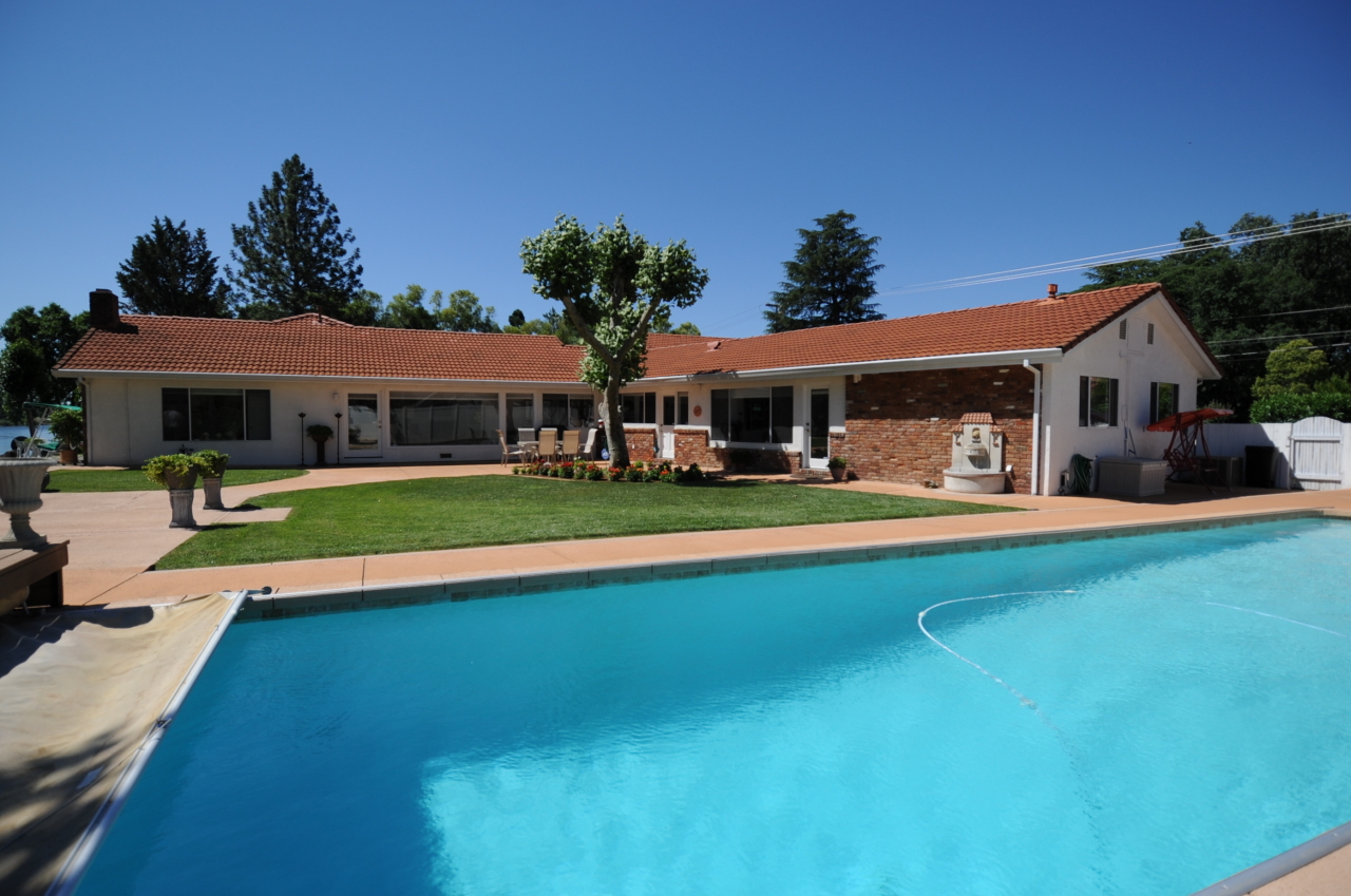 6471 Riverside Drive Redding, CA 96001 - Photo 8 of 56 a front view of a house with swimming pool yard and patio