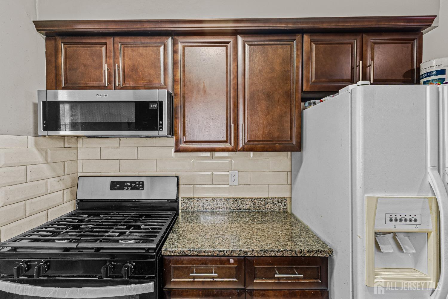 26 Brewster Circle Old Bridge, NJ 08857 - Photo 13 of 43 a kitchen with a stove and a microwave