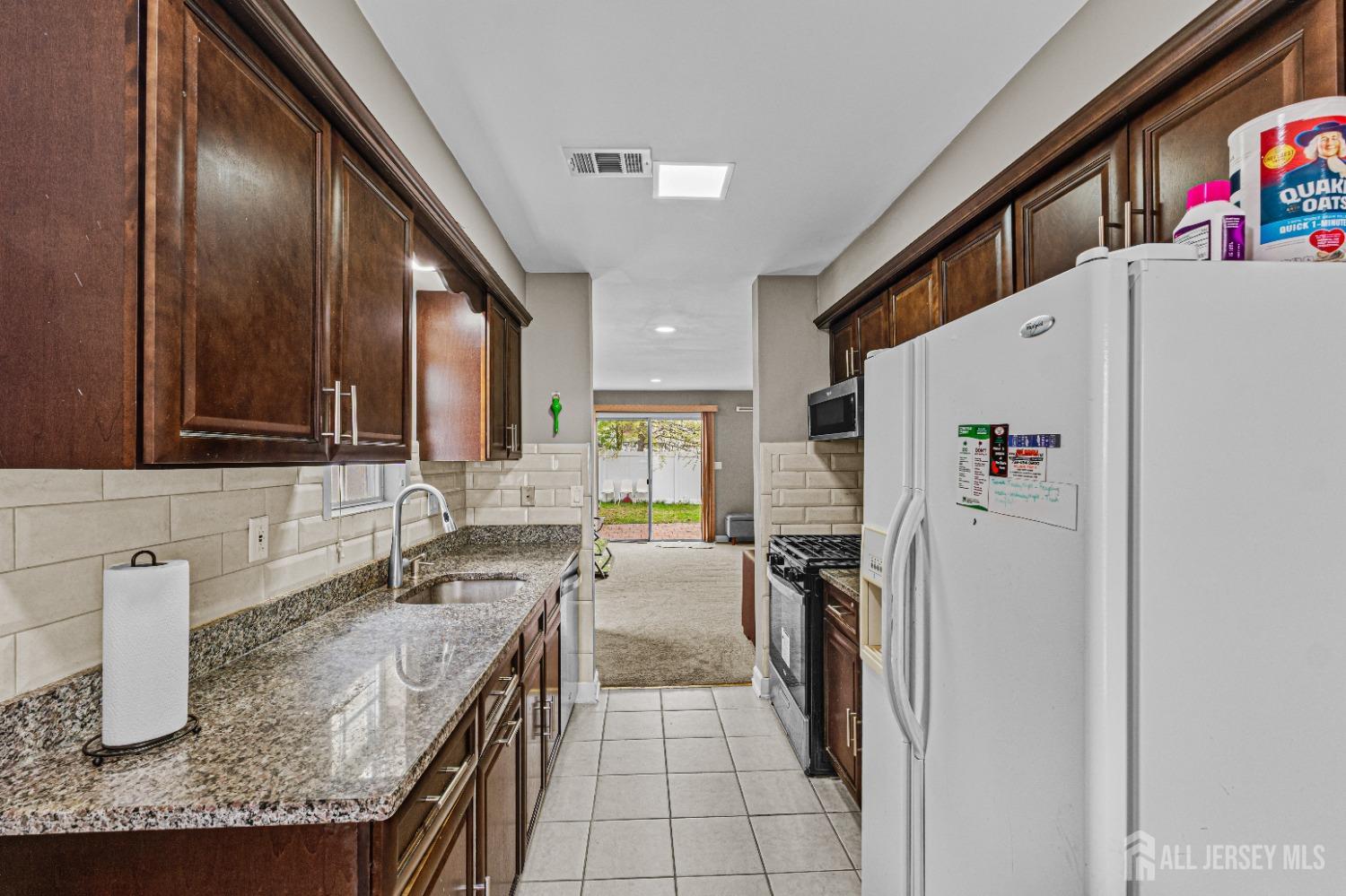 26 Brewster Circle Old Bridge, NJ 08857 - Photo 14 of 43 a kitchen with a refrigerator and a sink