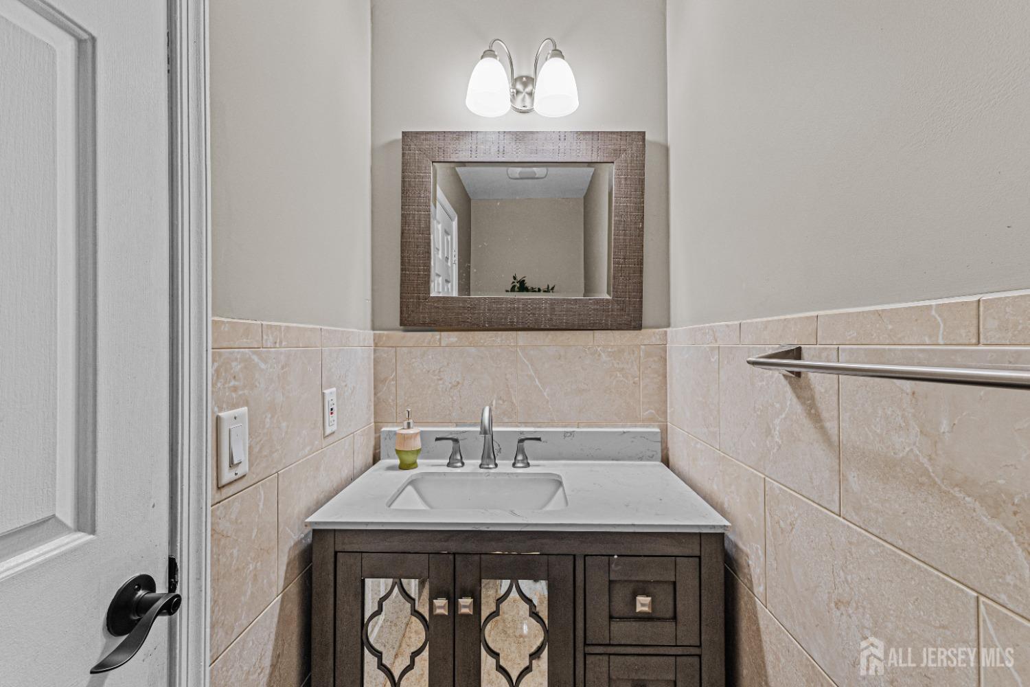 26 Brewster Circle Old Bridge, NJ 08857 - Photo 19 of 43 a view of a utility room with a sink and a mirror