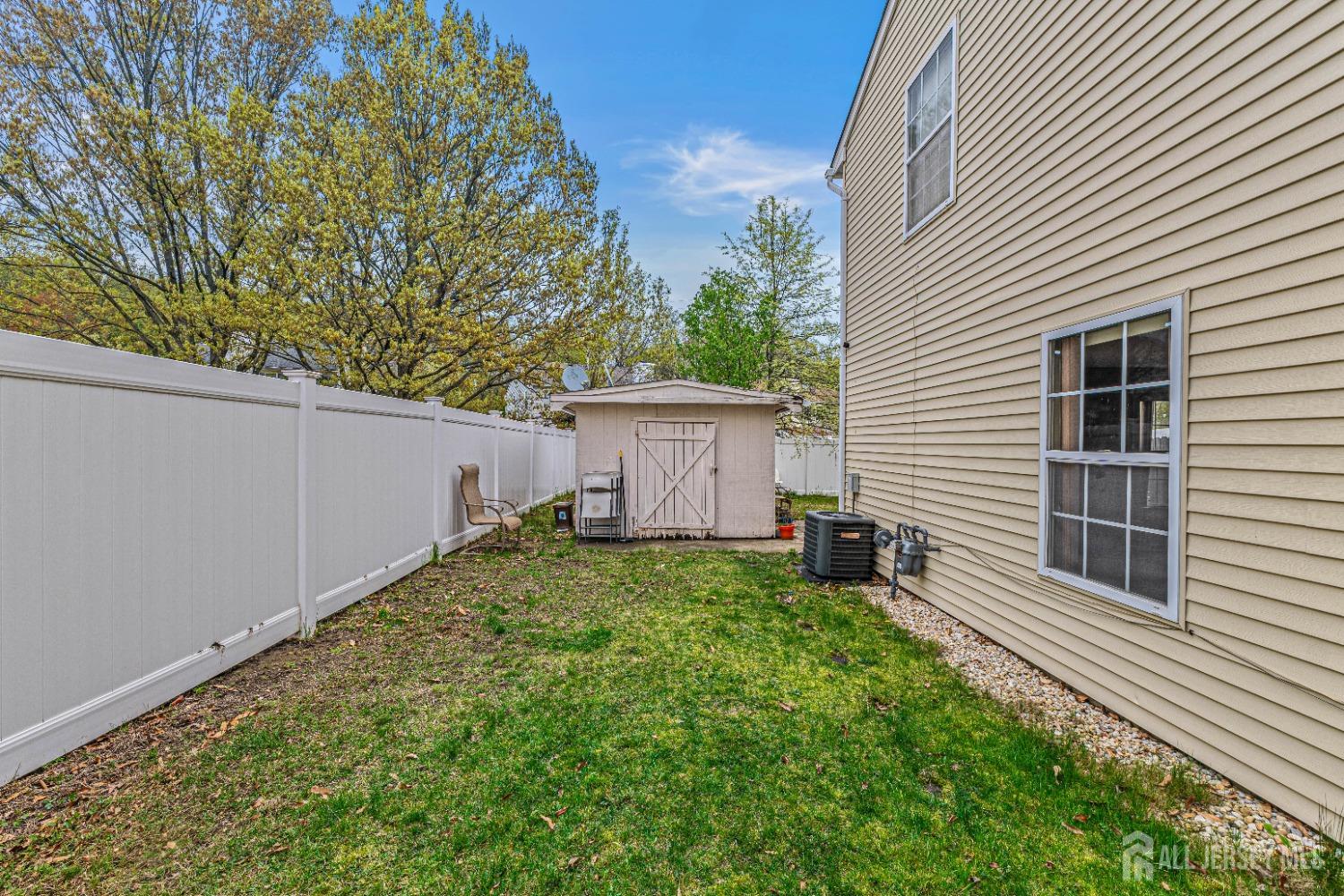 26 Brewster Circle Old Bridge, NJ 08857 - Photo 35 of 43 a view of a backyard with plants and a garage
