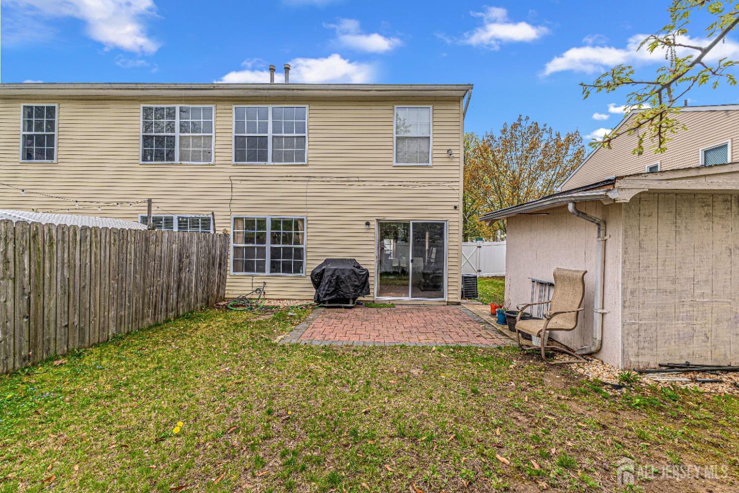 26 Brewster Circle Old Bridge, NJ 08857 - Photo 37 of 43 a backyard of a house with table and chairs