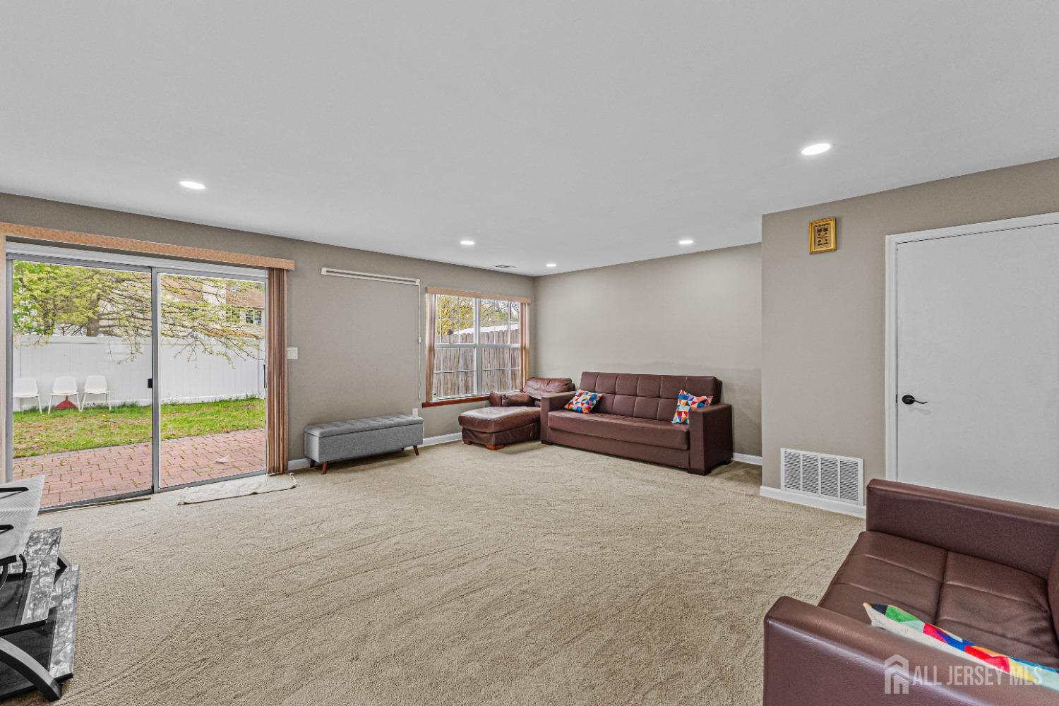 26 Brewster Circle Old Bridge, NJ 08857 - Photo 9 of 43 a living room with furniture and a flat screen tv