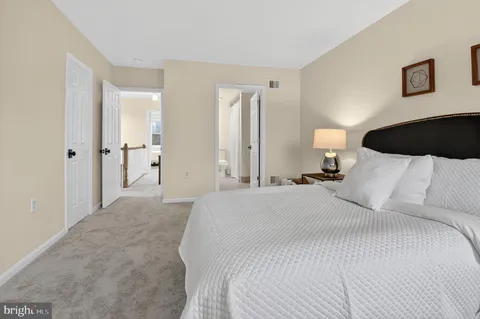 a bedroom with a bed and a lamp