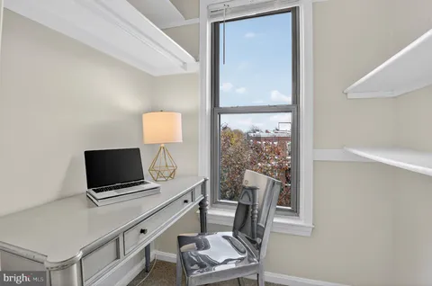 a living room with a flat screen tv and a window
