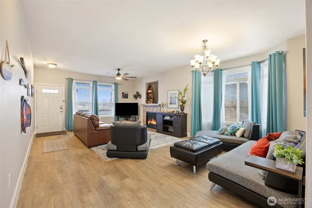 a living room with furniture and a chandelier