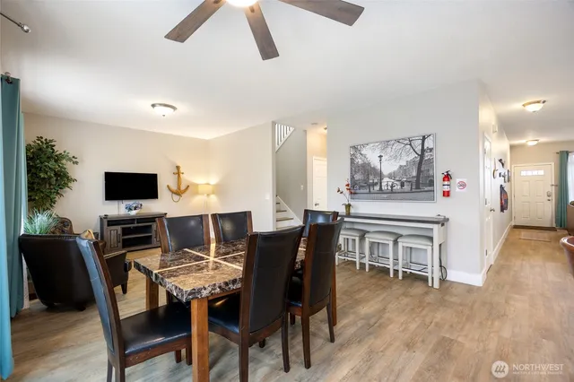 a view of a dining room with furniture and wooden floor
