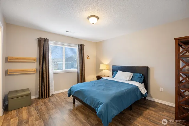 a bedroom with a bed and window