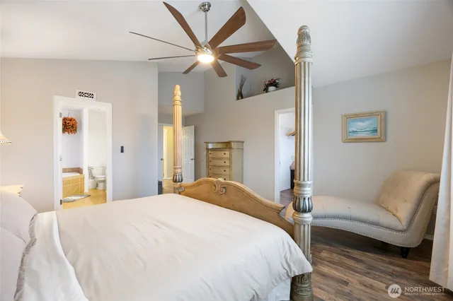 a bedroom with a bed couch and a window