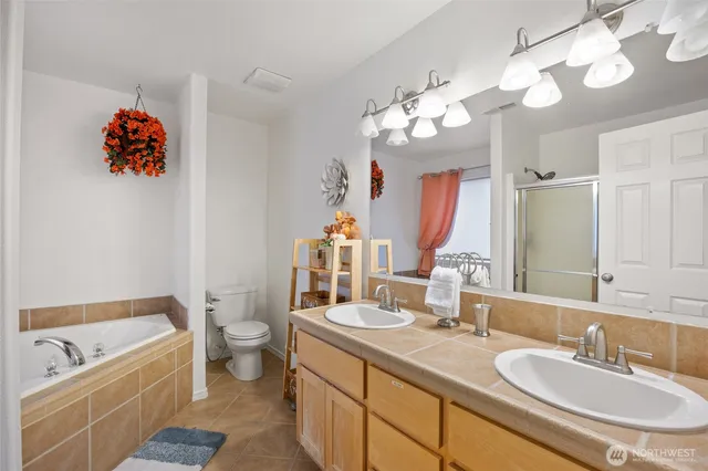 a bathroom with a tub a sink and a mirror