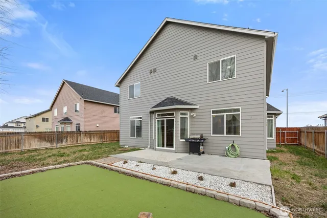 a front view of a house with a garden and yard