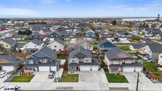 an aerial view of residential houses with city view