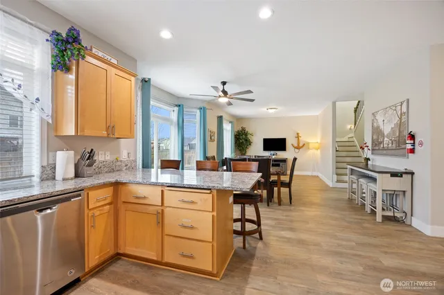 a large kitchen with lots of counter top space and stainless steel appliances